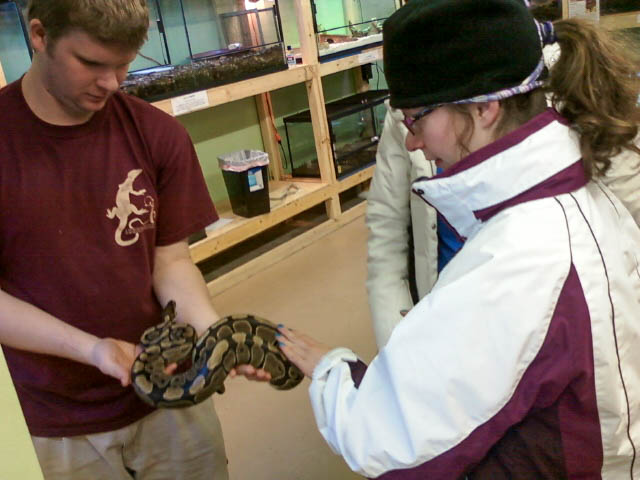 young man holding snake